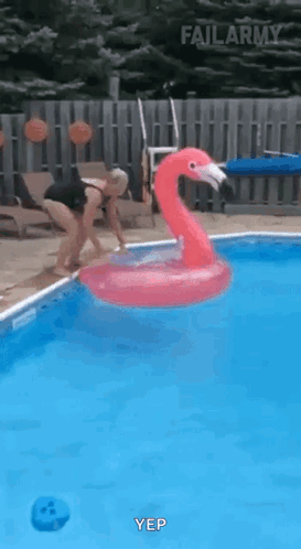 Woman Jumping Into Pool With Flamingo Float
