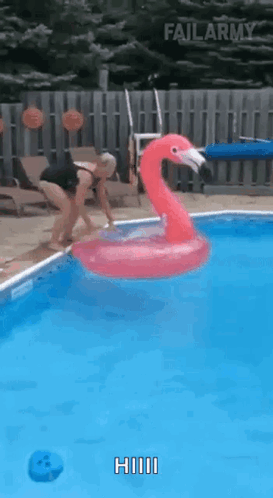 Woman Jumping Into Pool With Inflatable Flamingo