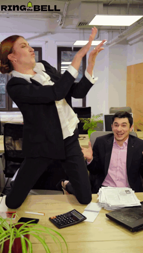 Woman Jumping Man at Desk With Calculator and Papers