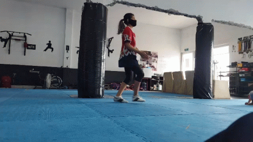 Woman Jumping on Blue Gym Mat
