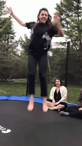 Woman Jumping on Trampoline, Another Watching