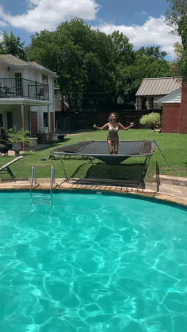 Woman Jumping On Trampoline Outside GIF