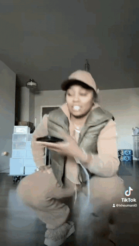 Woman Kneeling Holding Cell Phone GIF
