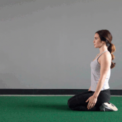 Woman Kneeling On Green Mat GIF