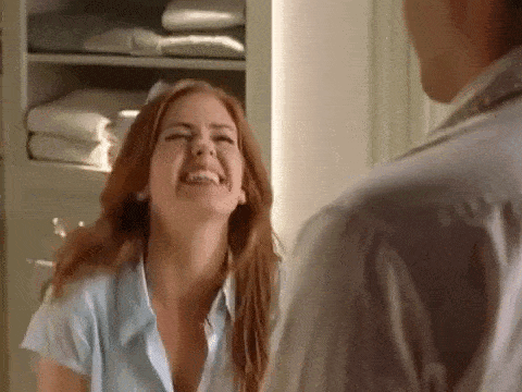 Woman Laughing at Man in Mirror
