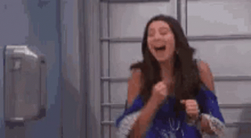 Woman Laughing Holding Fist in Air