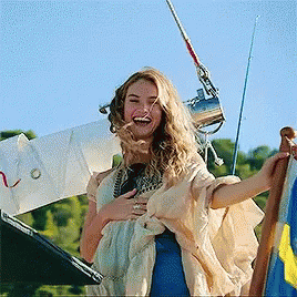 Woman Laughing Holding Flag GIF