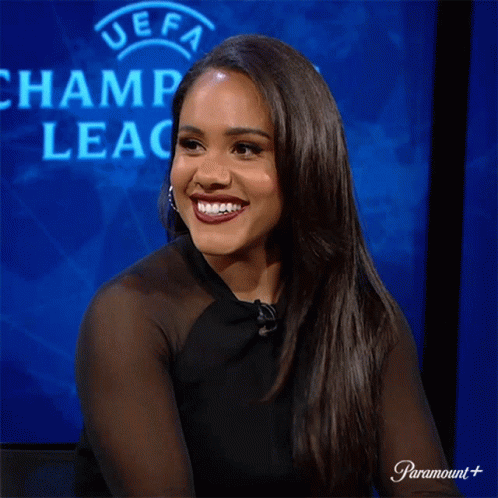 Woman Laughing in Front of UEFA Champions Logo