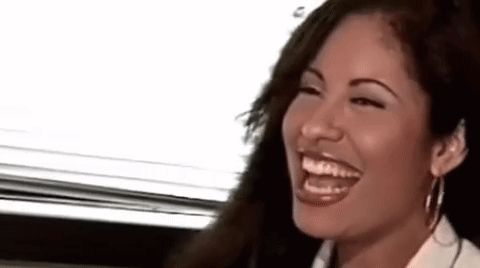 Woman Laughing With Eyes Closed in White Shirt