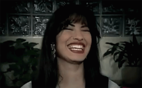 Woman Laughing With Eyes Closed Near Plant