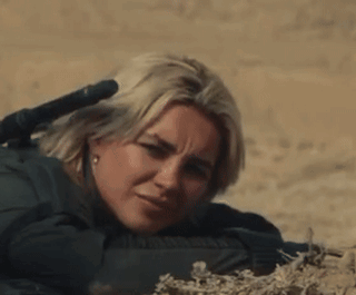 Woman Laying Down With Rifle