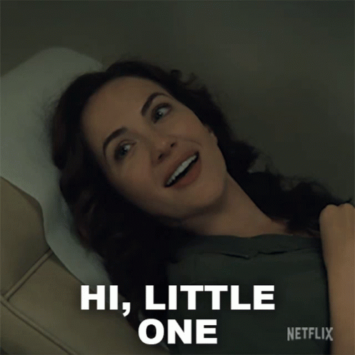 Woman Laying in Hospital Bed Saying Hi Little One