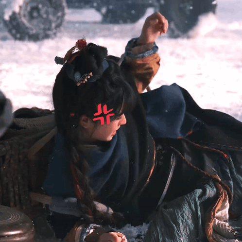 Woman Laying in Snow With Red Symbol on Forehead