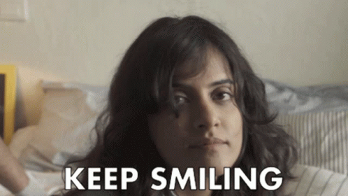 Woman Laying On Bed Keep Smiling On Face GIF