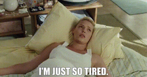 Woman Laying on Bed Saying I'm Just So Tired