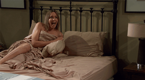 Woman Laying On Bed With Pillow GIF