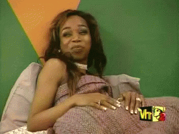 Woman Laying on Bed With Sign VH1
