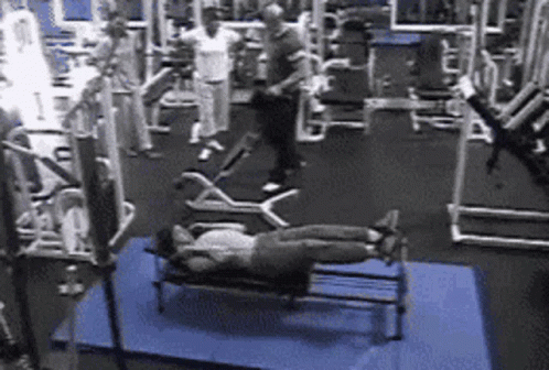 Woman Laying on Bench in Gym