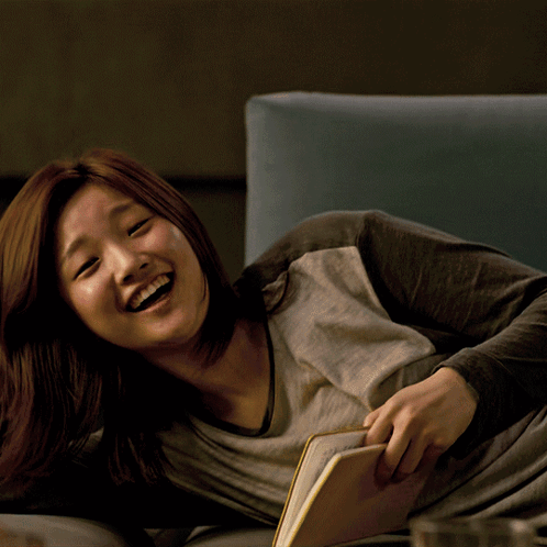 Woman Laying On Couch Reading Book GIF