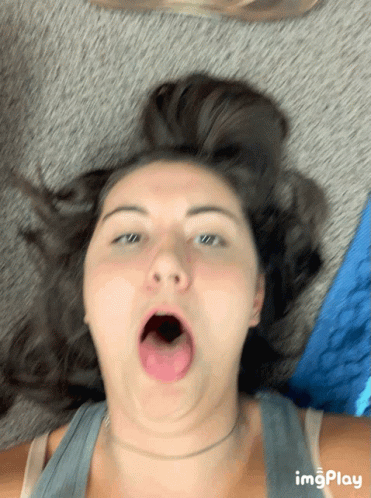 Woman Laying On Floor With Mouth Open GIF