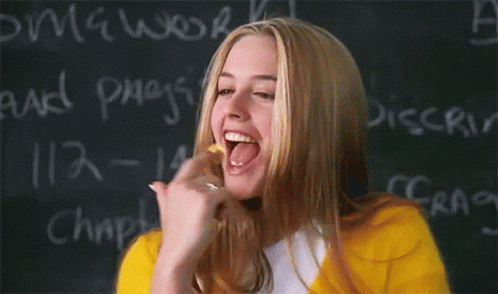 Woman Licking Finger Near Blackboard Homework
