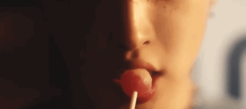 Woman Licking Lollipop Close-Up GIF