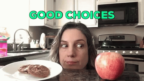 Woman Looking at Apple and Cookies Good Choices