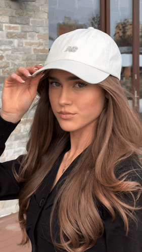Woman Looking at Camera White New Balance Hat