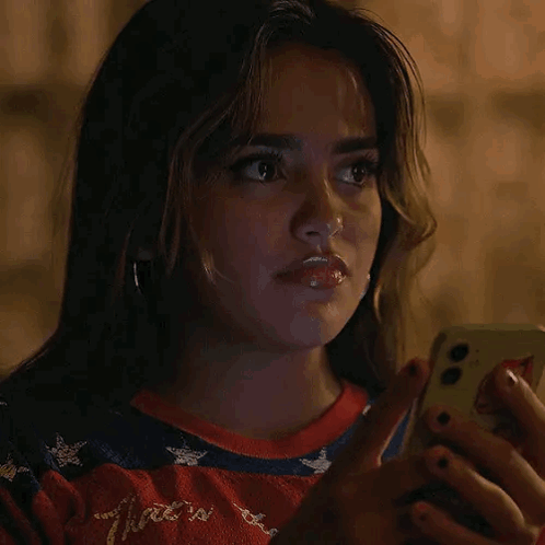 Woman Looking at Cell Phone in Dark