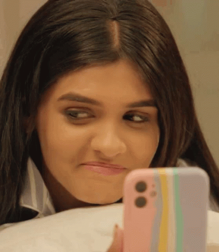 Woman Looking at Cell Phone Making Face