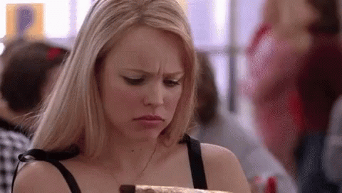Woman Looking at Chocolate Cake in Crowded Room