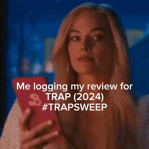 Woman Looking at Phone Me Logging My Review for Trap 2024