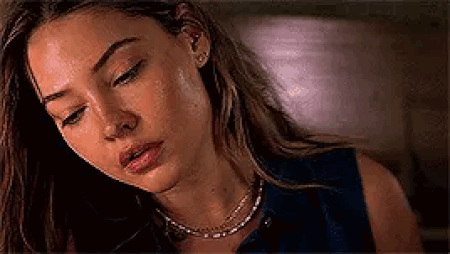 Woman Looking Down With Necklace And Earrings GIF