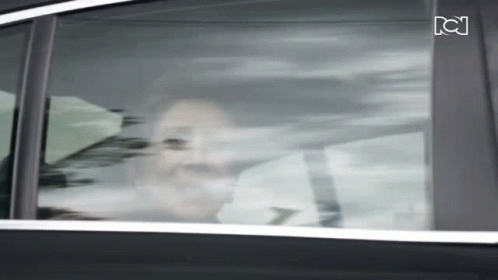 Woman Looking Out Car Window With Letter C