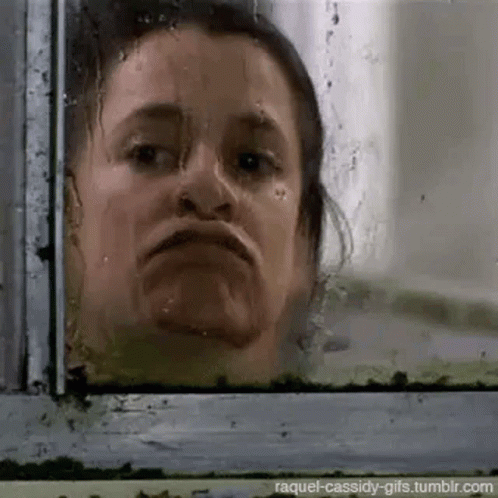 Woman Looking Out The Window GIF