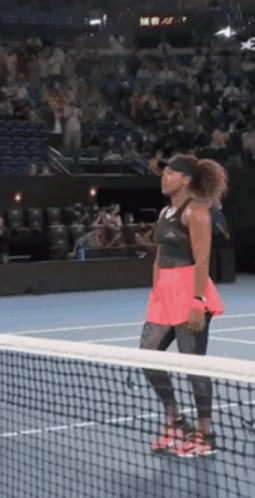 Woman Looking Over Net on Tennis Court
