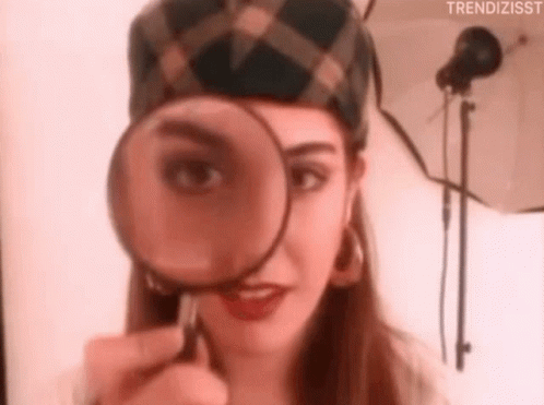 Woman Looking Through Magnifying Glass