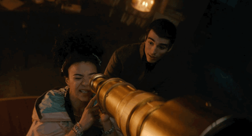 Woman Looking Through Telescope With Man
