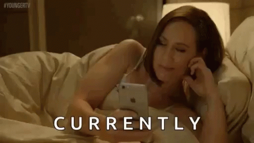 Woman Lying in Bed Talking on Phone