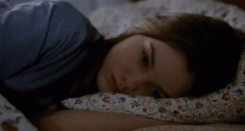 Woman Lying in Bed with Pillow
