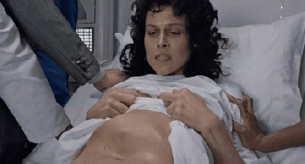 Woman Lying in Hospital Bed Being Examined