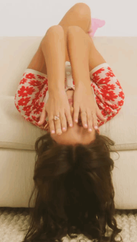 Woman Lying on Couch Covering Face