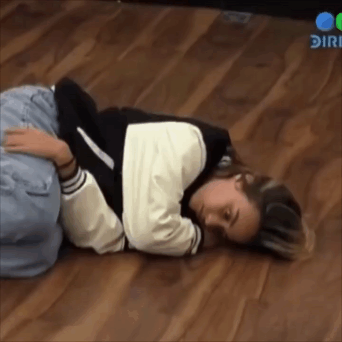 Woman Lying on Floor With Head on Knees