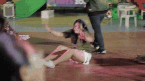 Woman Lying on Floor with May 20 Sign