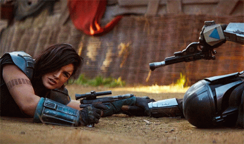 Woman Lying on Ground with Gun