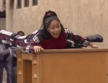 Woman Lying On Wooden Desk With Legs Crossed GIF
