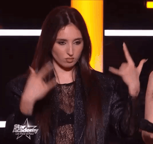 Woman Making Devil Horns Sign With Fingers