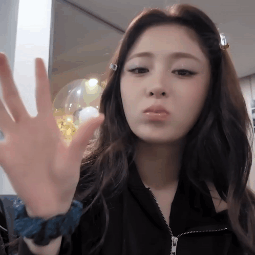 Woman Making Face in Black Jacket and Blue Wristband