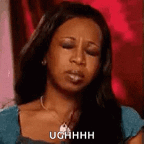 Woman Making Funny Face In Blue Shirt And Necklace GIF
