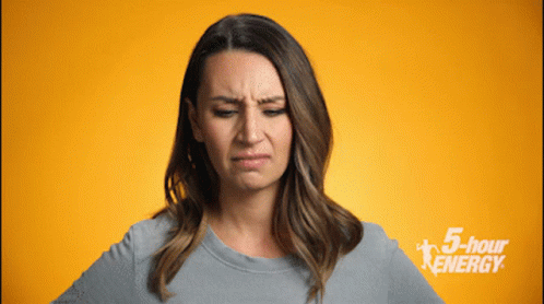 Woman Making Funny Face in Front of 5 Hour Energy Sign